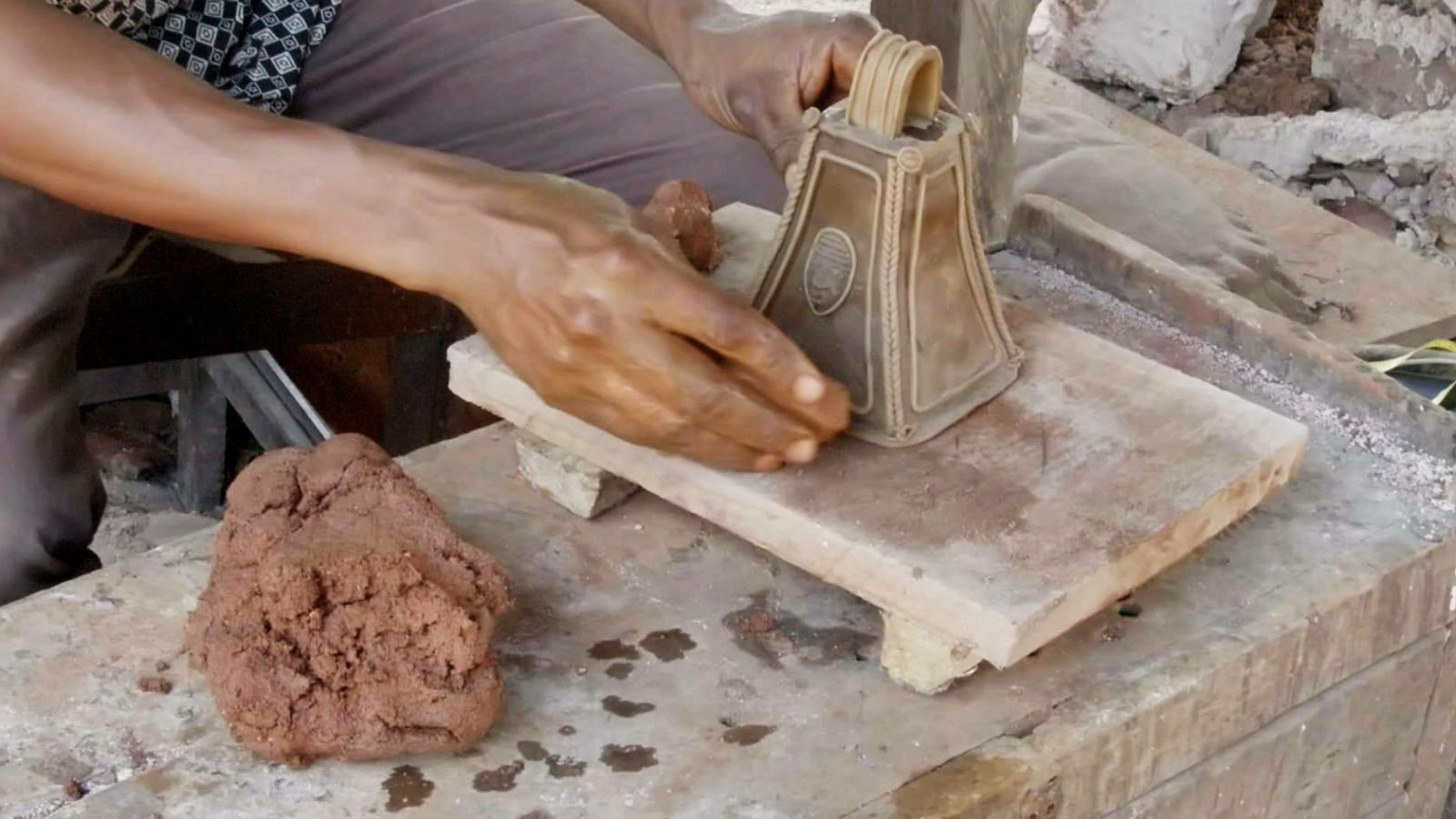 A clay core is coated with a layer of beeswax into which all the details, patterns, and decorations are worked. The wax model is then covered again with clay.